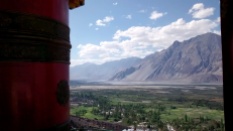 A prayer wheel at the Diskit monastery with the Nubra valley in the background